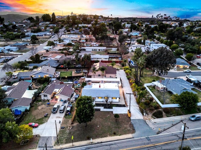 aerial view at dusk featuring a residential view