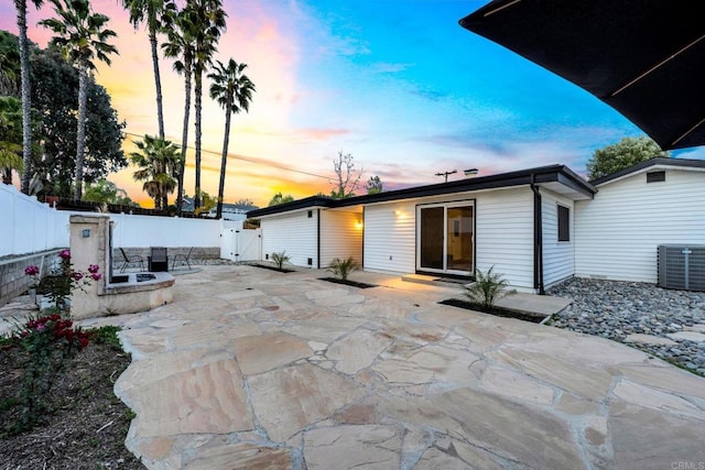 back of house with a patio area, a fenced backyard, a gate, and cooling unit