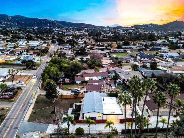 drone / aerial view featuring a residential view and a mountain view