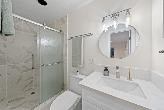 bathroom with toilet, a stall shower, and vanity