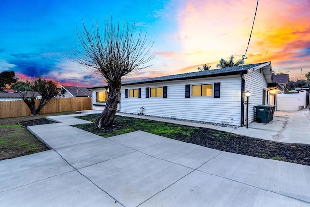 ranch-style house featuring fence