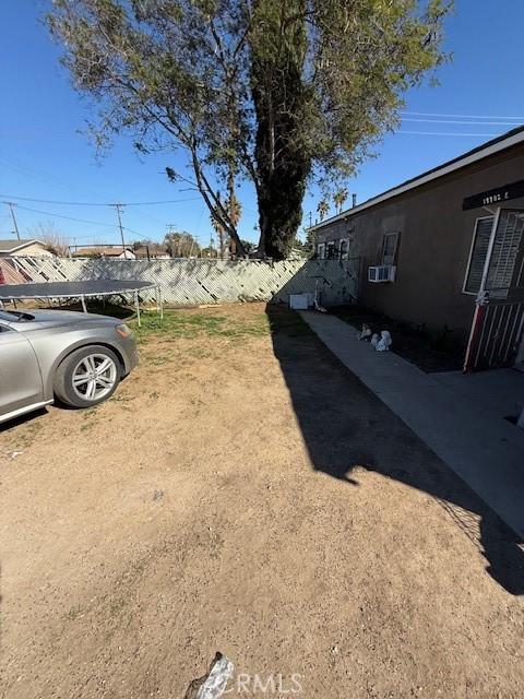 view of yard with cooling unit and fence