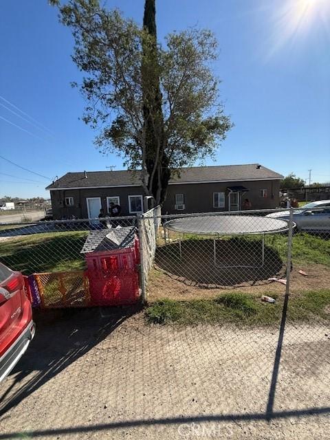 ranch-style home with fence