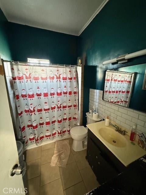 bathroom featuring toilet, curtained shower, tile patterned flooring, vanity, and tile walls