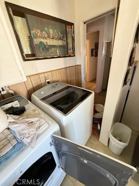 laundry area featuring washing machine and dryer, laundry area, and light tile patterned floors