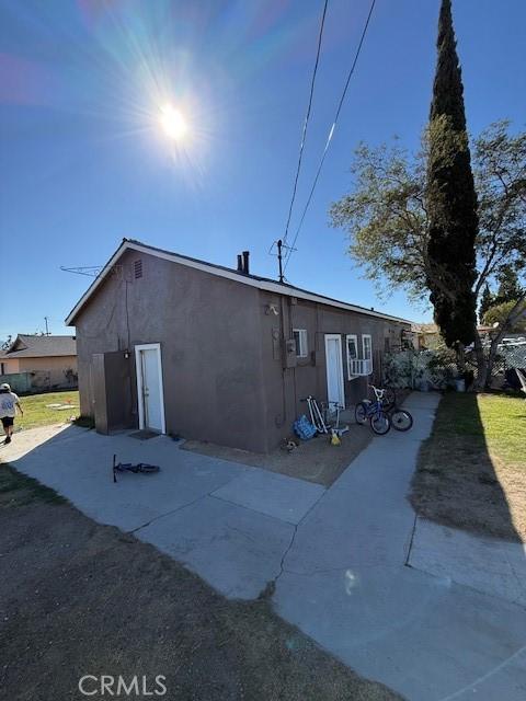 exterior space with a patio and stucco siding