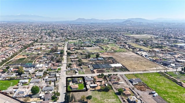 birds eye view of property with a mountain view