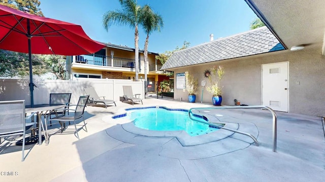 view of swimming pool with a patio area, fence, and a fenced in pool