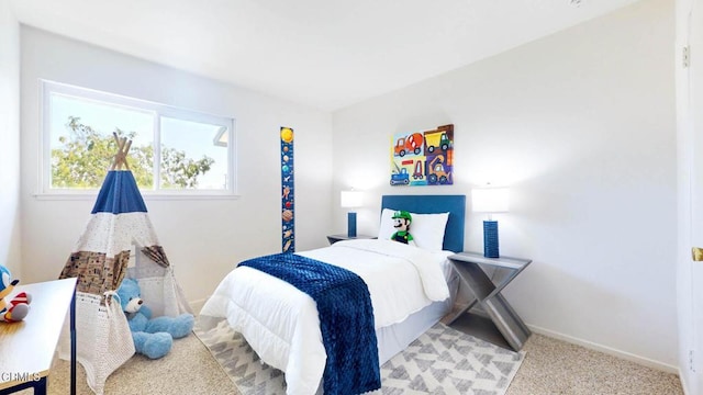 bedroom featuring baseboards and light colored carpet