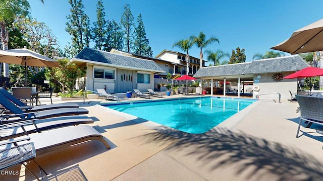 community pool featuring a patio and fence