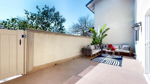 view of patio / terrace with a gate and an outdoor living space