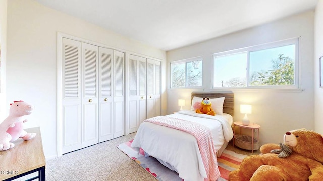 bedroom featuring carpet floors and two closets