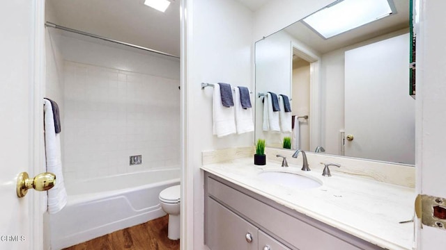 full bathroom with shower / tub combo with curtain, vanity, toilet, and wood finished floors