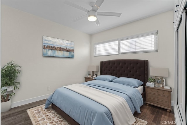 bedroom featuring ceiling fan, baseboards, and wood finished floors