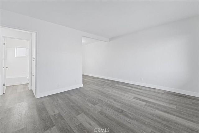 unfurnished room featuring wood finished floors and baseboards