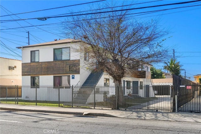 view of front of property featuring a fenced front yard and stucco siding