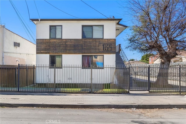 view of front of house featuring a fenced front yard and stucco siding