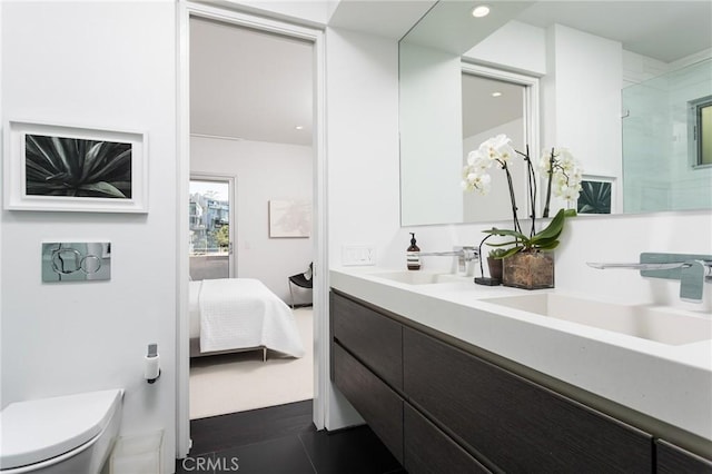 full bathroom featuring connected bathroom, a shower with shower door, toilet, and a sink