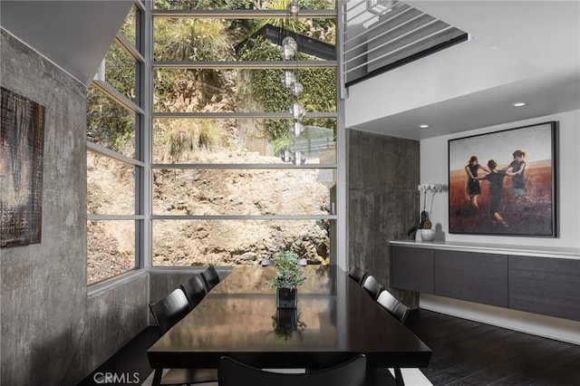 dining area featuring floor to ceiling windows and wood finished floors