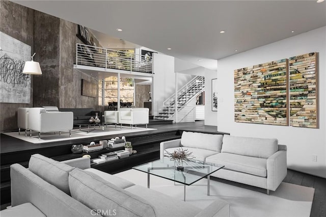 living area with stairway, recessed lighting, and wood finished floors