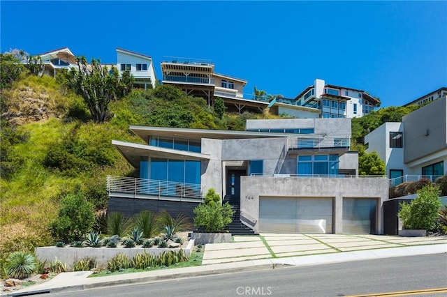 contemporary house featuring stairway, a garage, and stucco siding