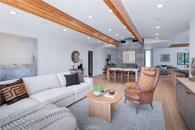 living area featuring vaulted ceiling with beams, light wood-style flooring, and recessed lighting