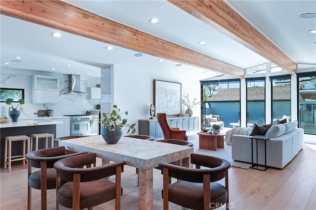 dining area featuring recessed lighting, beamed ceiling, and light wood finished floors