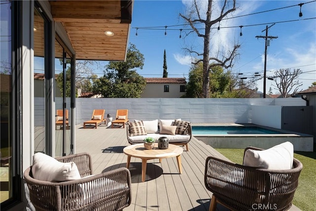 wooden deck featuring a fenced backyard, outdoor lounge area, and a fenced in pool