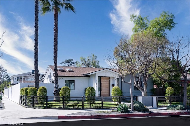 view of front of house with a fenced front yard and stucco siding