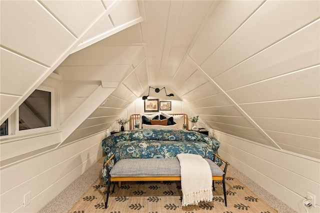 bedroom with vaulted ceiling, carpet floors, wood ceiling, and wooden walls