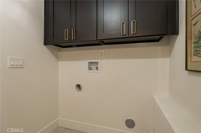 clothes washing area featuring light tile patterned floors, hookup for a washing machine, hookup for an electric dryer, baseboards, and cabinet space