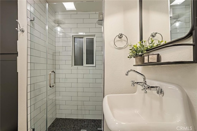 full bath featuring a stall shower and a sink