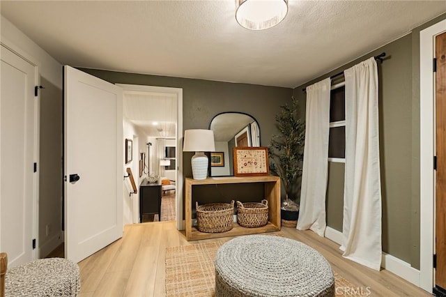 interior space featuring a textured ceiling and wood finished floors