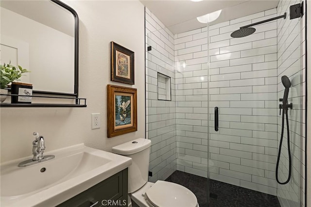 full bath featuring a shower stall, toilet, and vanity