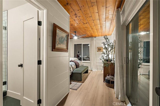 corridor featuring wooden ceiling and light wood-style floors