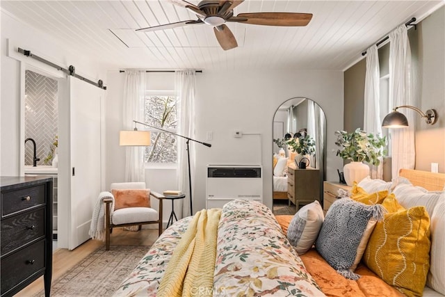 1149 Scenic Way, Rimforest, CA 92378 - bedroom with a barn door, heating unit, light wood-style floors, wooden ceiling, and ceiling fan
