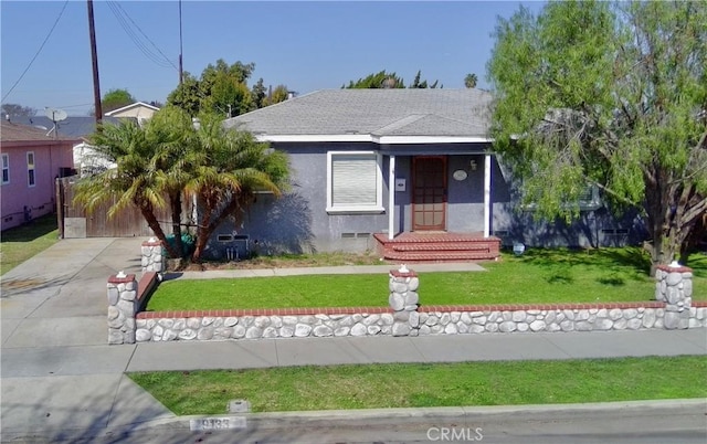 view of front of property featuring concrete driveway, roof with shingles, a front lawn, and stucco siding