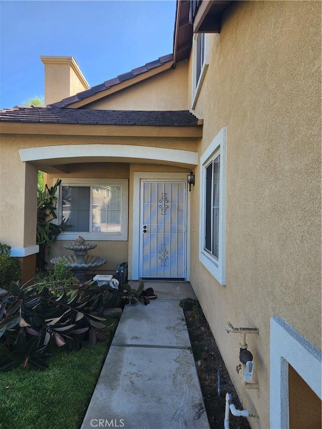 doorway to property with stucco siding