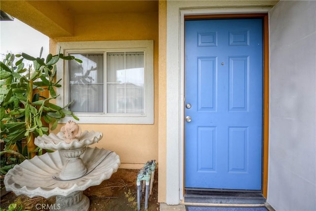 doorway to property with stucco siding