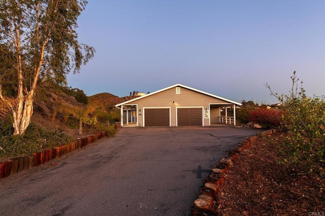 view of front of house featuring a garage, a mountain view, and aphalt driveway