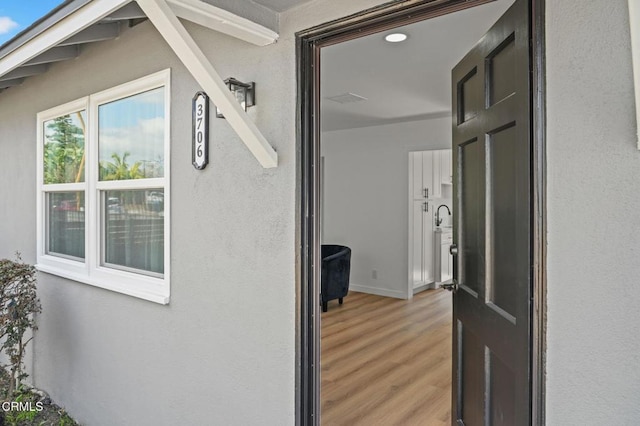 entrance to property with stucco siding