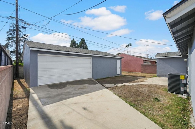 detached garage with fence and central air condition unit