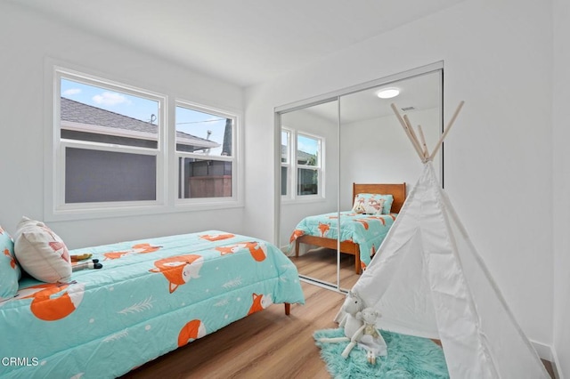 bedroom with a closet and wood finished floors