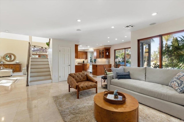 living area with stairway, visible vents, and recessed lighting