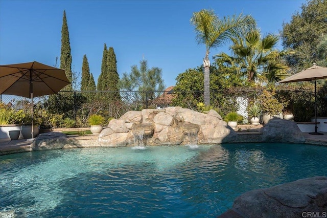 view of pool featuring fence