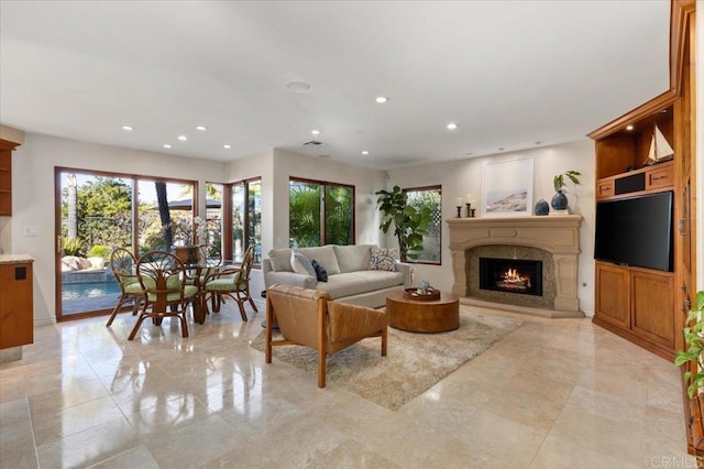 living area featuring recessed lighting and a fireplace