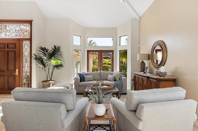 living area with french doors and a high ceiling