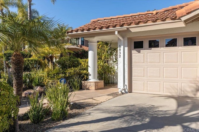 garage with concrete driveway