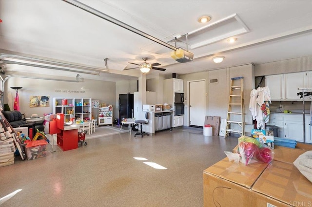 garage with freestanding refrigerator, a ceiling fan, and a garage door opener