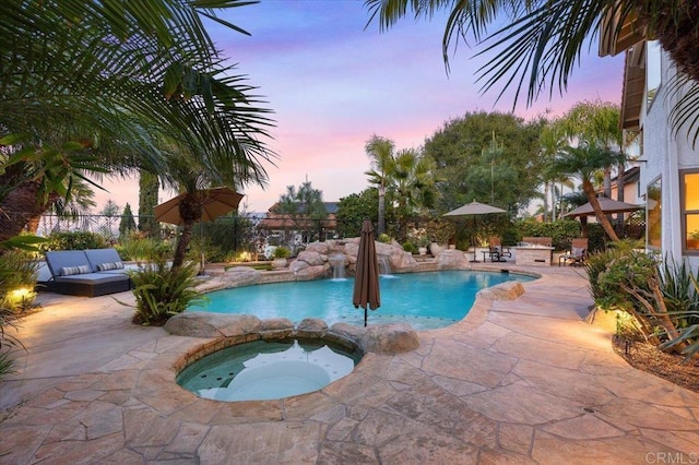 outdoor pool featuring fence, an outdoor hangout area, a patio, and an in ground hot tub